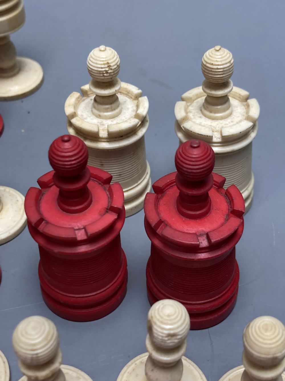 A late 19th century stained natural bone chess set